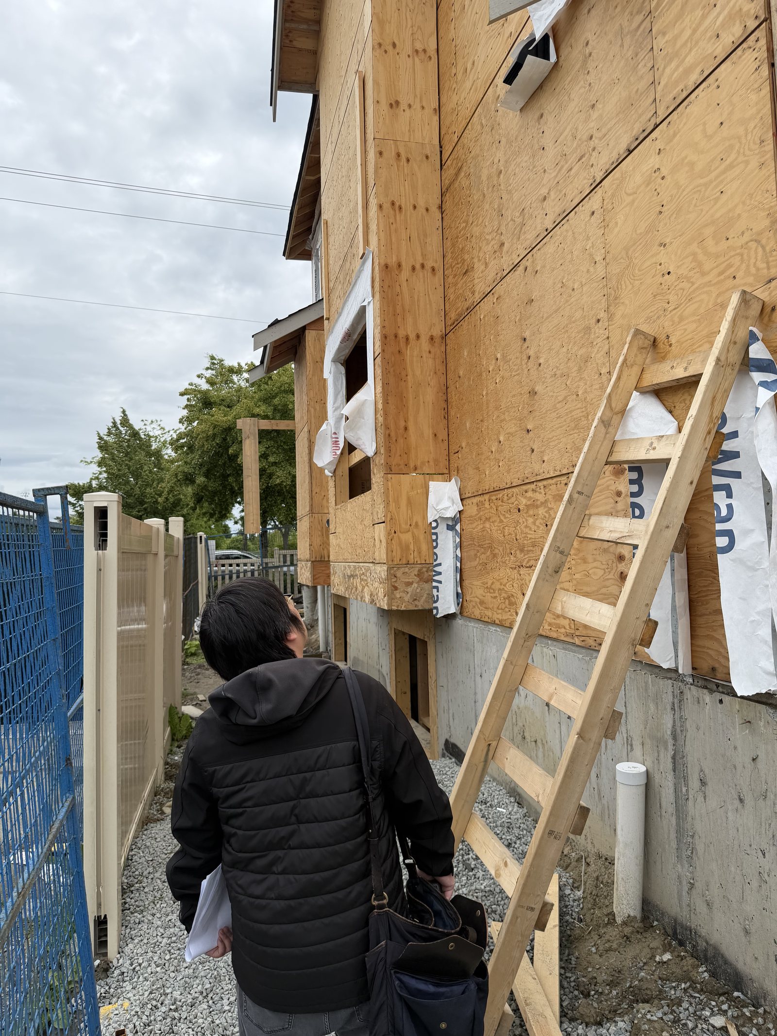 Structural engineering site review at a boarded construction project
