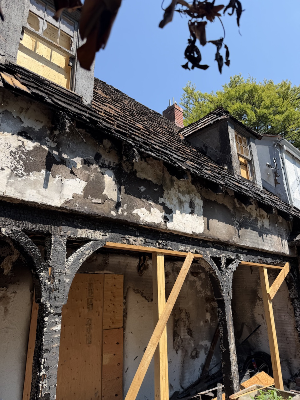 Fire-damaged exterior wall with temporary support framing