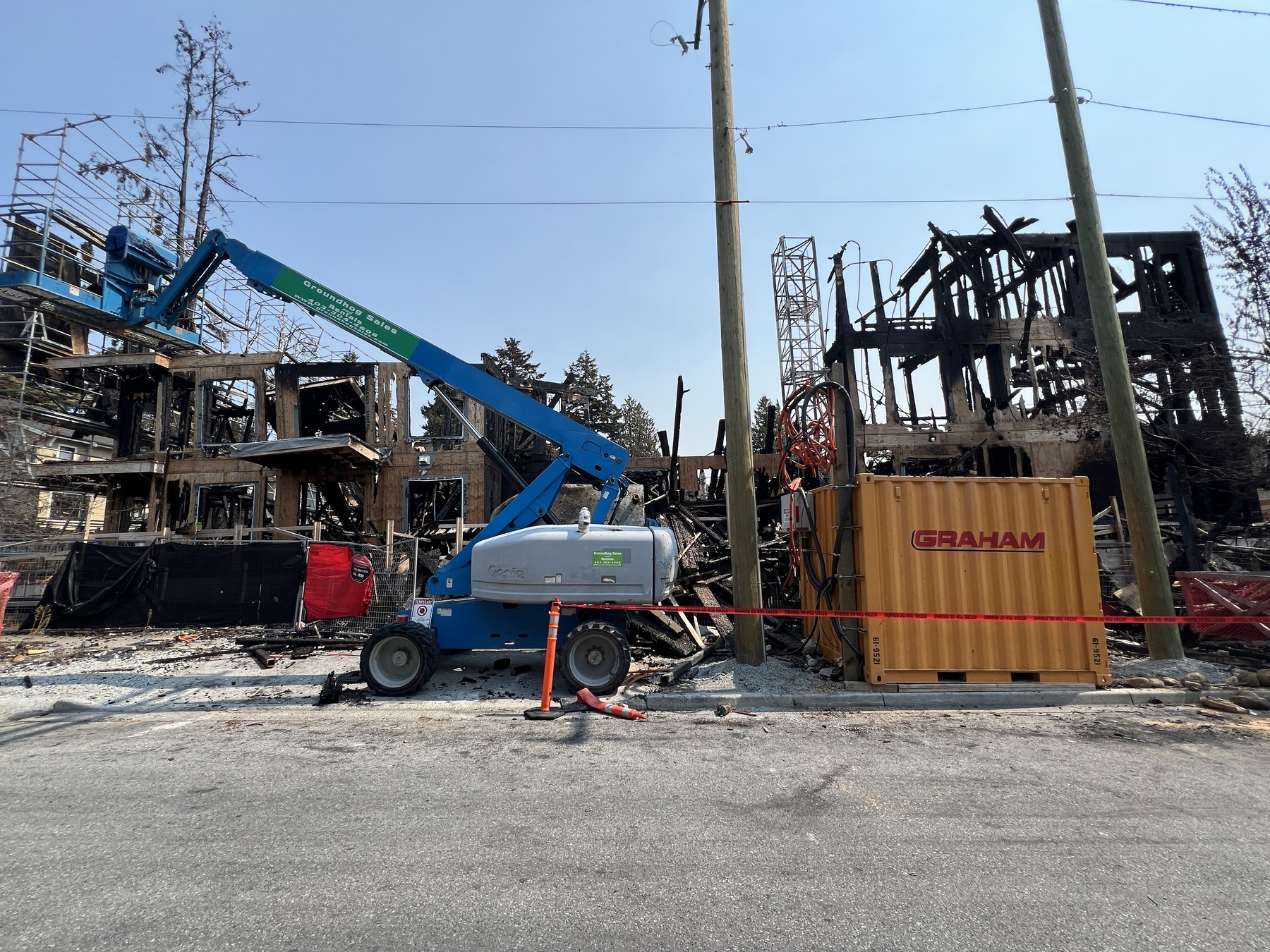 Fire-damaged wood-frame construction site after the crane collapse