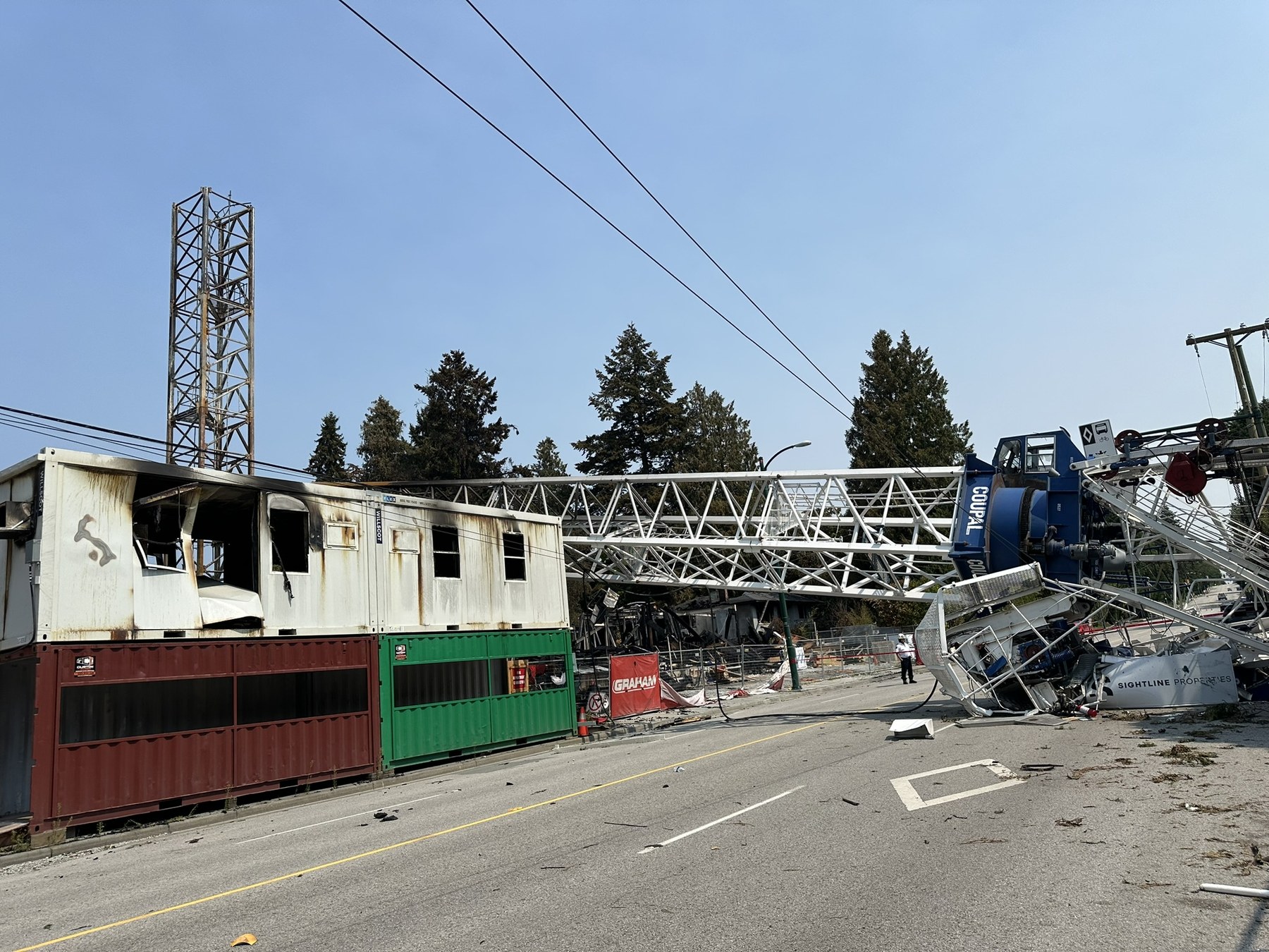 Collapsed crane across a roadway after a fire