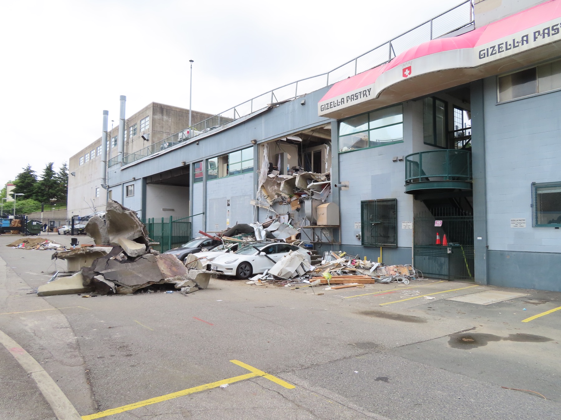 Wide overview of property damage after the Lougheed Highway parkade collapse