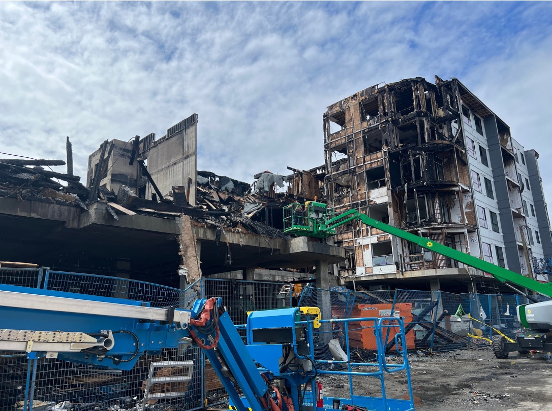 Large fire-damaged commercial and residential structure under review