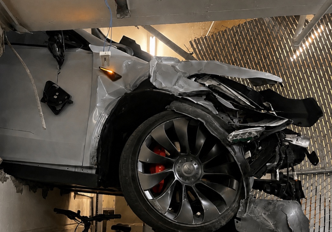 Close-up of a vehicle impact against building framing and ceiling finishes